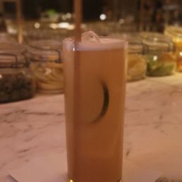 a glass of iced coffee on a counter