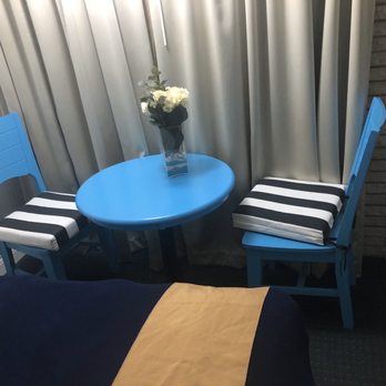 Gaido's Seaside Inn - Cute little sitting area inside the room with an exposed brick wall. Super cute!! - Hotels Near Me - Galveston, Texas