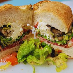 La Murgia Market Bakery And Butchery - Secret Sicilian Panini: A symphony of savory meats, creamy ricotta, rustic mushrooms, and zesty pesto in a toasted embrace.