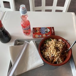 a bowl of food and a drink on a table a bowl of food and a drink on a table