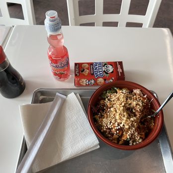 Poke Bop - a bowl of food and a drink on a table - Poke Near Me - Dallas, Texas Poke Bop - a bowl of food and a drink on a table - Poke Near Me - Dallas, Texas