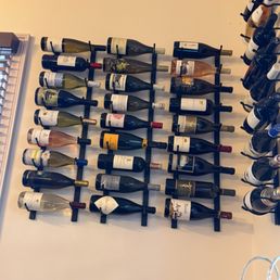 Wine racks hang around the room displaying some yummy wines.