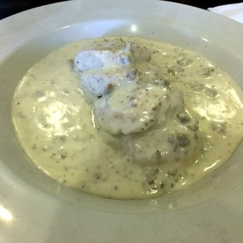 Orchard Cafe - Sausage Gravy Biscuits - two biscuits cut into half smothered with their sausage gravy - Breakfast & Brunch Near Me - Odenton, Maryland Orchard Cafe - Sausage Gravy Biscuits - two biscuits cut into half smothered with their sausage gravy - Breakfast & Brunch Near Me - Odenton, Maryland