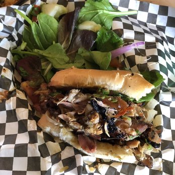 Coco Hut - Half of jerk chicken poboy. Delicious. - Caribbean Near Me - New Orleans, Louisiana