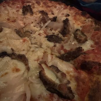 Hart's Saloon - A close-up of a perfectly baked cheese, onion, and morale pizza. - Pizza Near Me - Hebron, Illinois
