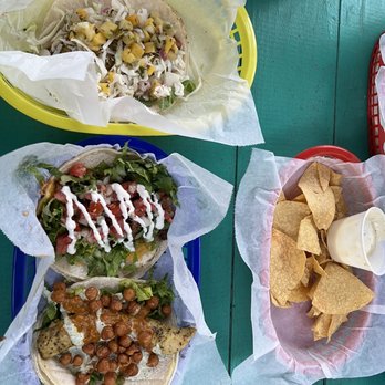 White Duck Taco Shop - Tacos from the top-bottom: thai peanut chicken, steak and cheese, and tikka masala chicken. On the right is chips and queso - Tacos Near Me - Arden, North Carolina White Duck Taco Shop - Tacos from the top-bottom: thai peanut chicken, steak and cheese, and tikka masala chicken. On the right is chips and queso - Tacos Near Me - Arden, North Carolina