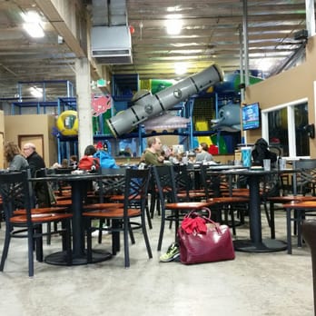 PlayDate SEA - Part of their seating area w/ kid equip in the background. - Playgrounds Near Me - Seattle, Washington