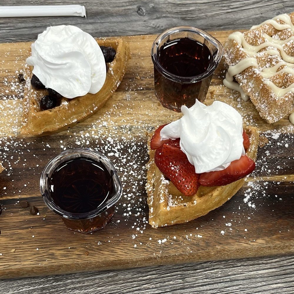 Biscuits Cafe - Waffle flight:chocolate chip, strawberry, blueberry and churro.  Side of sausage - Breakfast & Brunch Near Me - Glendale, Arizona