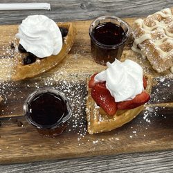 Biscuits Cafe - Waffle flight:chocolate chip, strawberry, blueberry and churro. Side of sausage