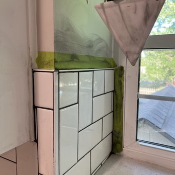 Custom Stone Tile - Grout and tape smeared on the walls.  More small pieces making tile work look lopsided. - Flooring Near Me - Mission, Kansas