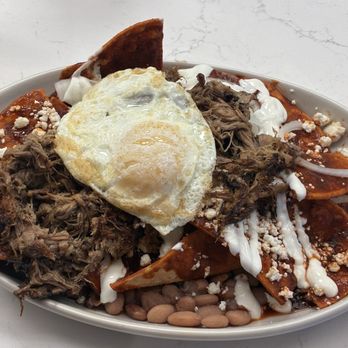 The Joy Bus Diner - Chilaquiles with brisket add egg over easy - Breakfast & Brunch Near Me - Phoenix, Arizona