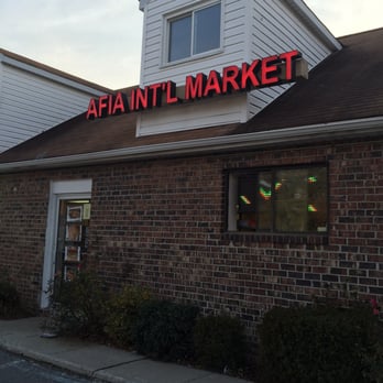 Afia International - a brick building with a neon sign - International Grocery Near Me - Elkridge, Maryland Afia International - a brick building with a neon sign - International Grocery Near Me - Elkridge, Maryland