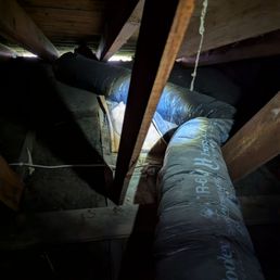 Another flex duct with no strapping making unnecessary bends and turns instead of being run straight and being pulled taught.
