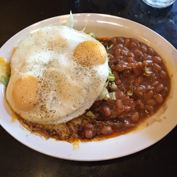 The New Mexicans - Two red enchiladas topped with a sunny side up egg. Side of frijoles, ya feel me? - New Mexican Cuisine Near Me - Everett, Washington The New Mexicans - Two red enchiladas topped with a sunny side up egg. Side of frijoles, ya feel me? - New Mexican Cuisine Near Me - Everett, Washington