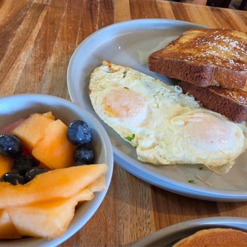 Kerbey Lane Cafe - Central - Poppy seed French toast with over easy medium eggs and fresh fruit - Tex-Mex Near Me - Austin, Texas Kerbey Lane Cafe - Central - Poppy seed French toast with over easy medium eggs and fresh fruit - Tex-Mex Near Me - Austin, Texas