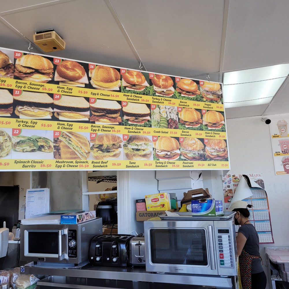 Donut Basket - a woman standing in front of a menu board - Donuts Near Me - Milpitas, California