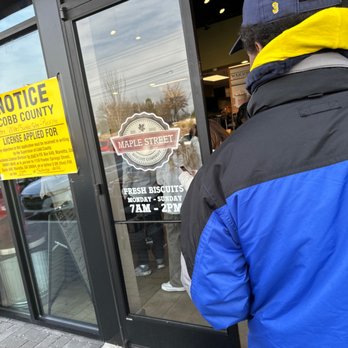 Maple Street Biscuit Company - a man standing in front of a store - Breakfast & Brunch Near Me - Kennesaw, Georgia