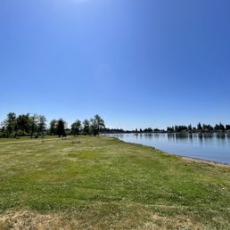 Picnic tables and benches, BBQ's and the water.