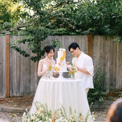 Athina’s Botanical Garden - This is an example of a transitional wedding arrangement first setting is a floral aisle marker that is later repurposed to the cake table.