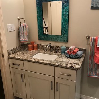 N&N Enterprises - a bathroom with a sink and mirror - General Contractors Near Me