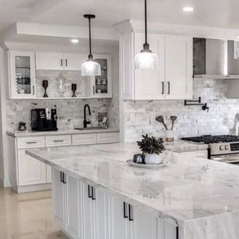 Martone Home Improvements - a kitchen with white cabinets and marble countertops - General Contractors Near Me Martone Home Improvements - a kitchen with white cabinets and marble countertops - General Contractors Near Me