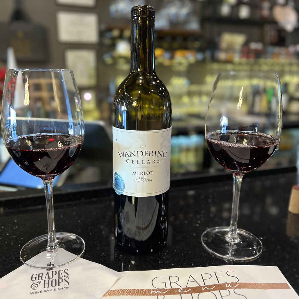 Grapes and Hops - a bottle of wine and two glasses of wine - Wine Bars Near Me - Scottsdale, Arizona Grapes and Hops - a bottle of wine and two glasses of wine - Wine Bars Near Me - Scottsdale, Arizona