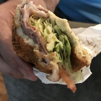 Subway - a man holding a sandwich with meat and lettuce - Sandwiches Near Me - Ephrata, Washington