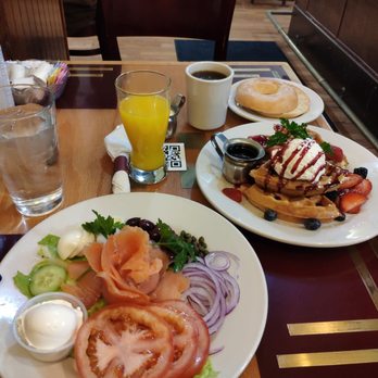 Frida's Breakfast & Lunch - Lox sandwich in grilled bagel, + waffle, OJ, and coffee with a cup of milk. - Breakfast & Brunch Near Me - Evanston, Illinois Frida's Breakfast & Lunch - Lox sandwich in grilled bagel, + waffle, OJ, and coffee with a cup of milk. - Breakfast & Brunch Near Me - Evanston, Illinois