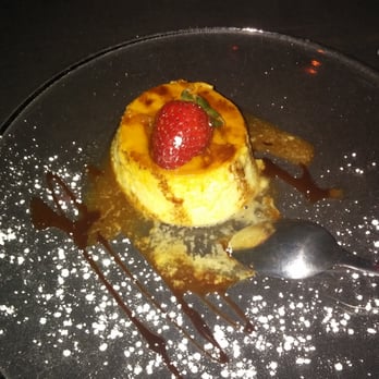 SOB's - Flan drizzled with chocolate sauce powdered sugar topped with a strawberry - Music Venues Near Me - New York, New York