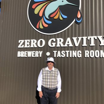 Zero Gravity Brewery - Sign in front of the brewery, with a devoted patron - Breweries Near Me - Burlington, Vermont