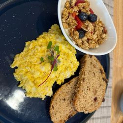 Flore Bakery - Scrambled eggs with artisan toast with cranberry and pumpkin seeds and a side of yogurt with granola