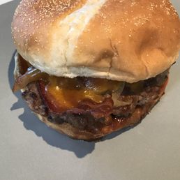Delicious Western burger with barbecue sauce, cheese, grilled onions, and bacon!