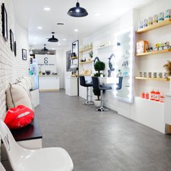 Sample Size Social - Showroom has a vast selection of products for retail. Center portion of the showroom used for barber, hairstyling and beauty services.