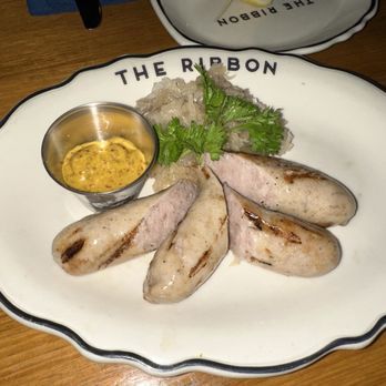 The Ribbon - Bratwurst (undercooked) from the Oktoberfest menu - New American Near Me - New York, New York The Ribbon - Bratwurst (undercooked) from the Oktoberfest menu - New American Near Me - New York, New York