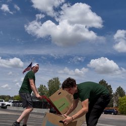 Employees picking up boxes