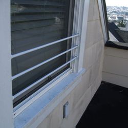 The Childproofer - Custom Iron Bars for the window - painted white.