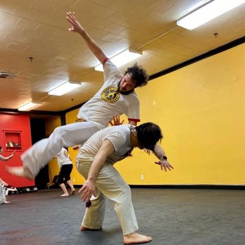 The Capoeira Forge - Capoeira student jumping over his opponent. - Martial Arts Near Me - Sacramento, California The Capoeira Forge - Capoeira student jumping over his opponent. - Martial Arts Near Me - Sacramento, California