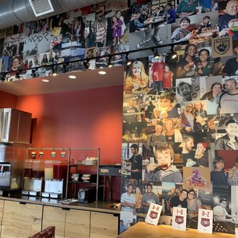 MOD Pizza - a wall full of photos of people - Pizza Near Me - Raleigh, North Carolina