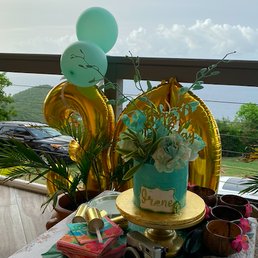 One-tier rum cake with pineapple and coconut cream filling. Decorated with natural orchids and hand-painted detailing.