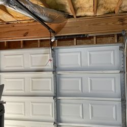 Garage door spring system install wide view photo.
