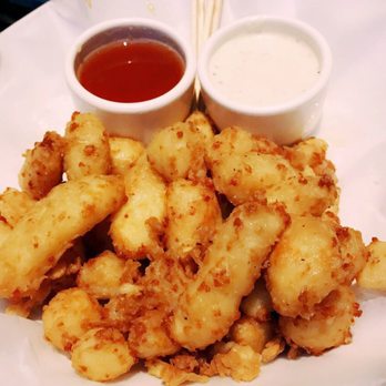 Yard House - Cheese Curds in a buttermilk batter with a honey hot sauce or horseradish aioli dip. Honey Hot Sauce is amazing with the cheese curds!! - New American Near Me - Austin, Texas