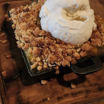 Kankakee Grille South Bend - Warm peach cobbler. Baked and served in cast iron. Vanilla ice cream. - American Near Me - South Bend, Indiana Kankakee Grille South Bend - Warm peach cobbler. Baked and served in cast iron. Vanilla ice cream. - American Near Me - South Bend, Indiana