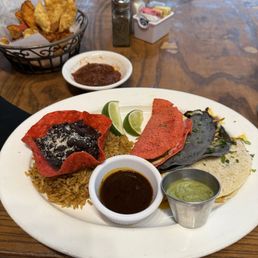 An amazing set of Quesabirria tacos served with beans and rice.