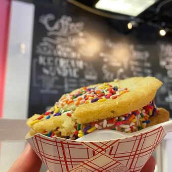 Main Street Ice Cream - a hand holding an ice cream sandwich with sprinkles and sprinkles - Ice Cream & Frozen Yogurt Near Me - Fort Pierce, Florida Main Street Ice Cream - a hand holding an ice cream sandwich with sprinkles and sprinkles - Ice Cream & Frozen Yogurt Near Me - Fort Pierce, Florida
