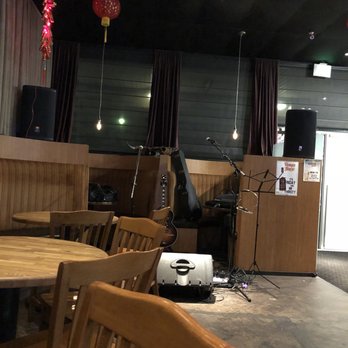 Bin 73 - a room with a table, chairs, speakers, and a speaker system - Tapas Bars Near Me - Oklahoma City, Oklahoma