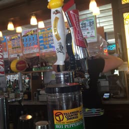 a man filling a beer at the bar a man filling a beer at the bar
