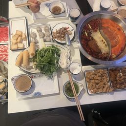 Spicy soup base and tomato soup base combination meat and seafood and veggies