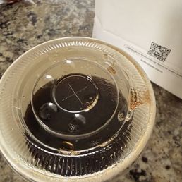 A three fourths of the way filled coke with no ice. A three fourths of the way filled coke with no ice.