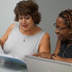 Women Venture - Teamwork: two aspiring entrepreneurs work together during the Small Business Essentials class