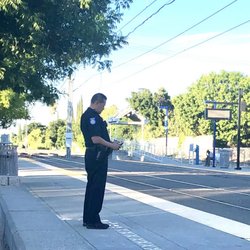 SACRT Light Rail - Watt/Manlove Station - I do believe the Police Officer is keeping his eye on me.  [Heading back downtown from our training site.]